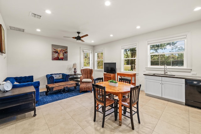 dining area with light tile patterned flooring, ceiling fan, and sink