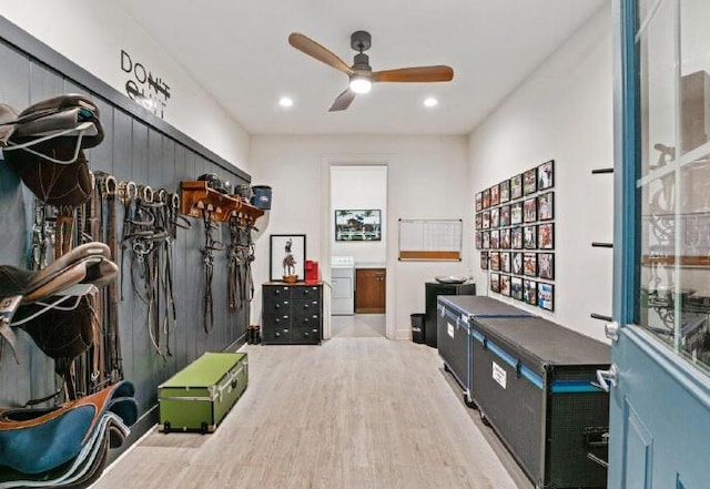 interior space with ceiling fan, washer / dryer, and light hardwood / wood-style floors