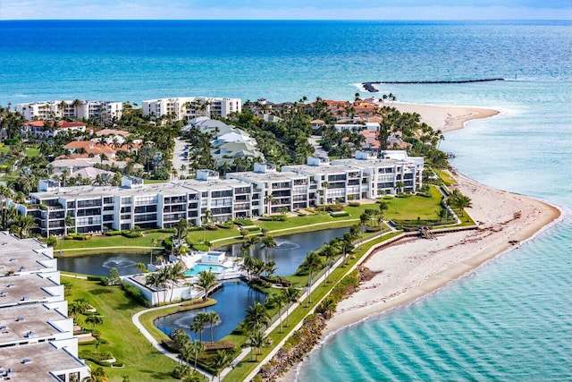 drone / aerial view with a water view and a beach view