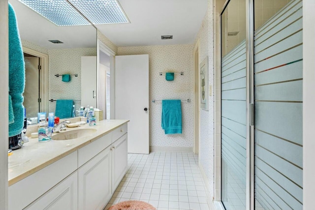 bathroom with vanity, tile patterned flooring, and a shower with door