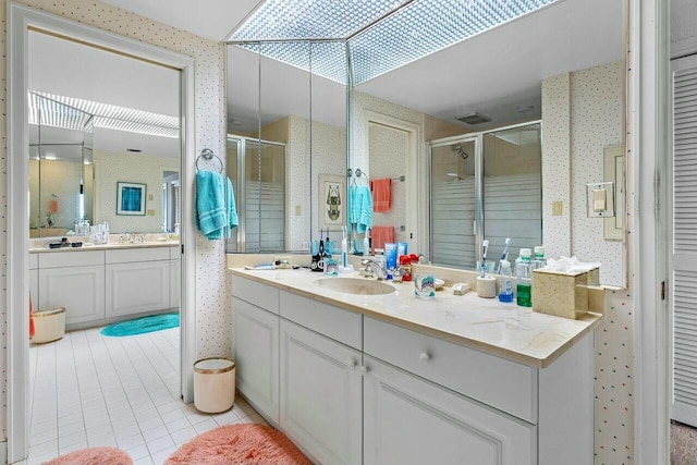 bathroom with tile patterned floors, walk in shower, and vanity