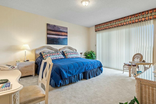 bedroom with a textured ceiling and carpet flooring