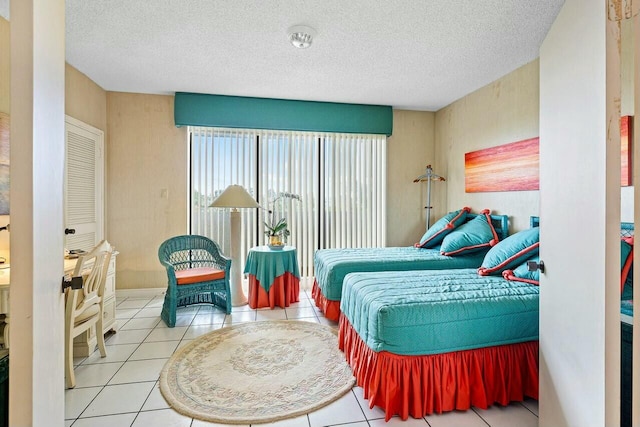 bedroom featuring tile patterned floors and a textured ceiling