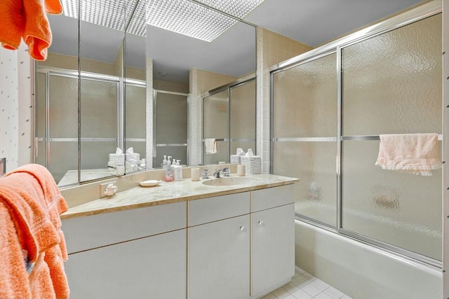 bathroom with enclosed tub / shower combo, tile patterned flooring, and vanity