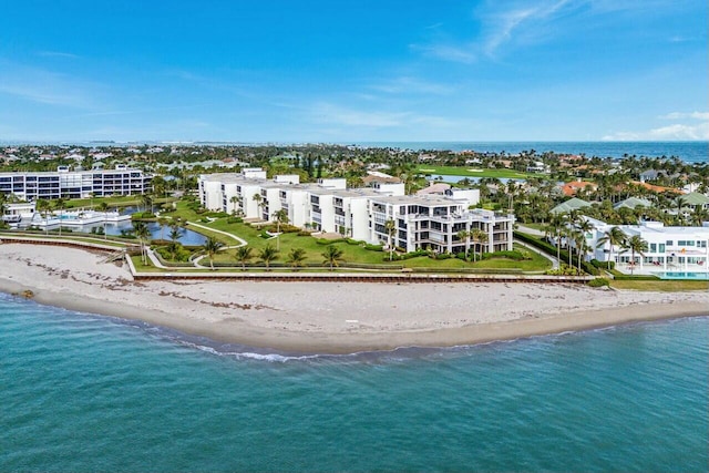 birds eye view of property featuring a water view and a beach view