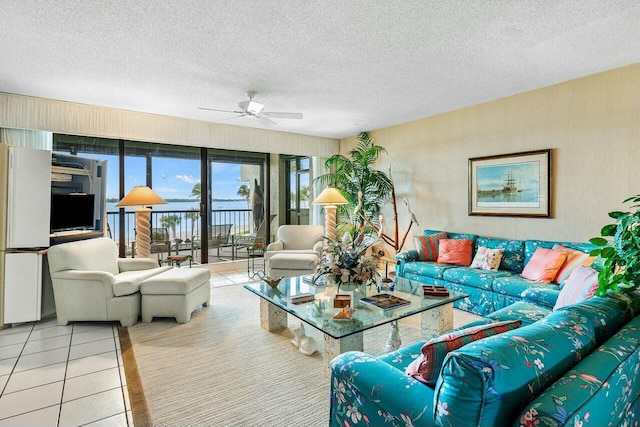 tiled living room with ceiling fan and a textured ceiling