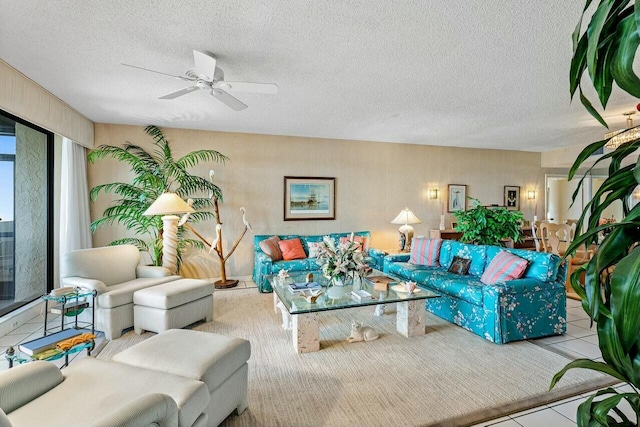 tiled living room with ceiling fan and a textured ceiling