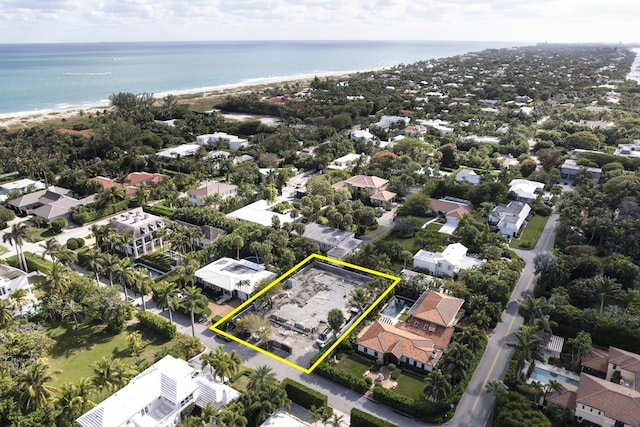 drone / aerial view with a water view, a residential view, and a view of the beach