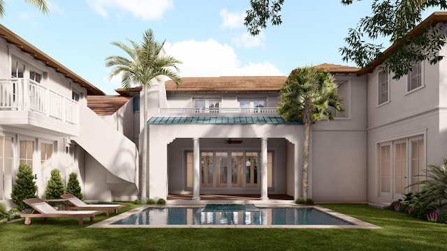 back of property featuring stucco siding, a standing seam roof, ceiling fan, a balcony, and an outdoor pool