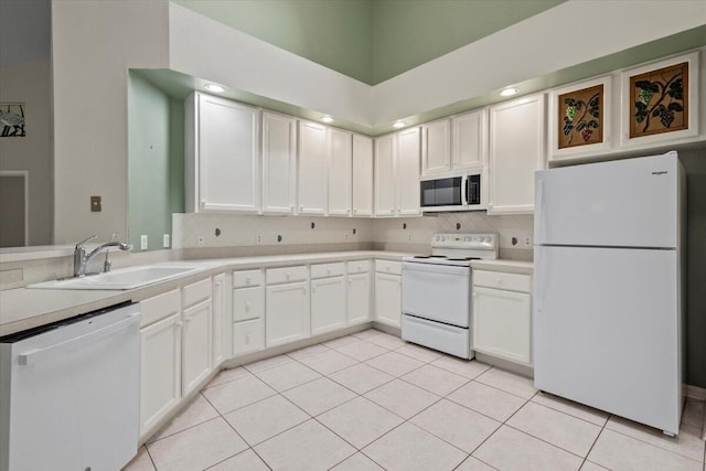 kitchen featuring white appliances, sink, white cabinets, light tile patterned flooring, and tasteful backsplash