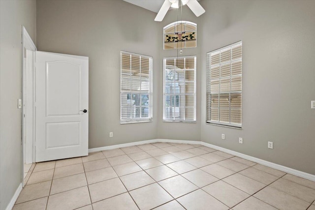 tiled spare room featuring ceiling fan