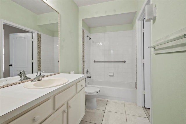 full bathroom with toilet, tiled shower / bath combo, tile patterned flooring, and vanity