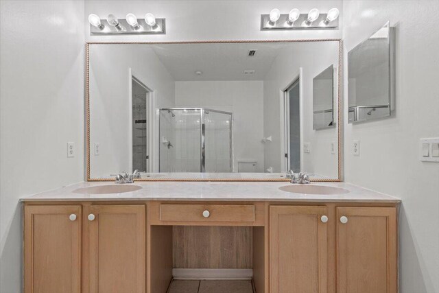 bathroom with vanity, tile patterned flooring, and a shower with shower door