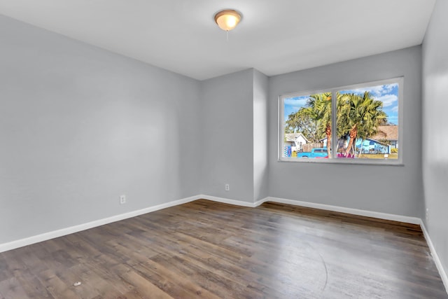 unfurnished room featuring dark hardwood / wood-style floors