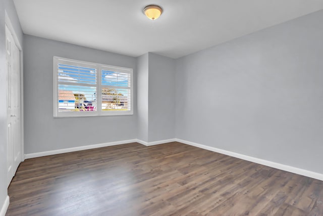 empty room featuring dark wood-type flooring