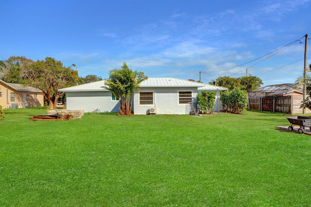 rear view of property featuring a yard