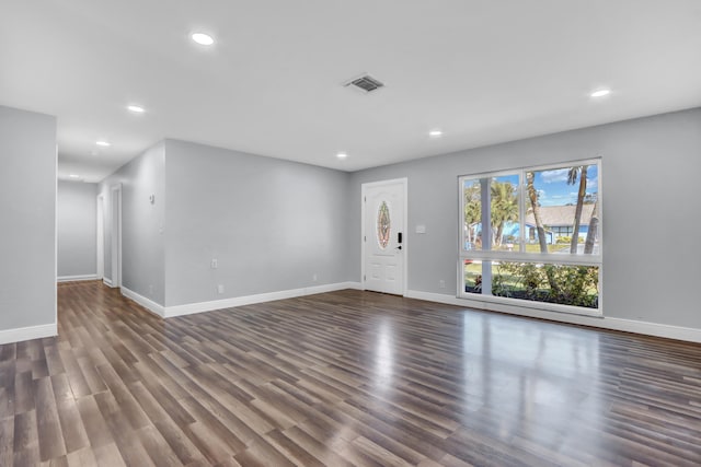 unfurnished living room featuring dark hardwood / wood-style flooring