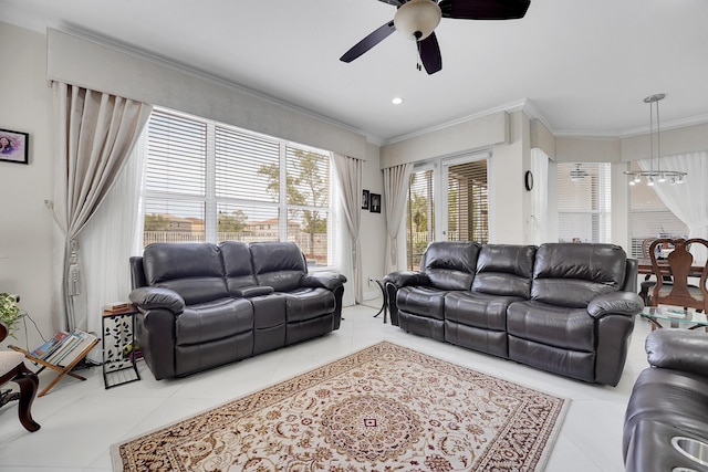 living room featuring tile patterned flooring, crown molding, and ceiling fan with notable chandelier