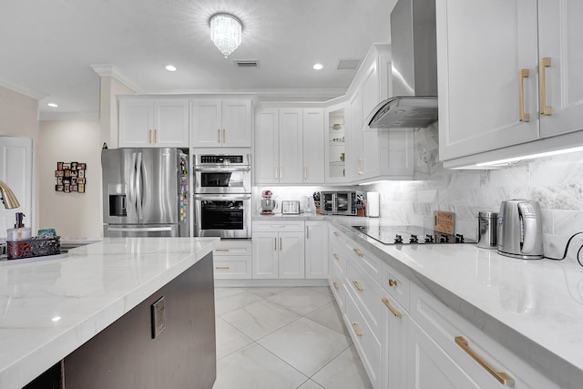 kitchen with decorative backsplash, white cabinetry, appliances with stainless steel finishes, and wall chimney exhaust hood