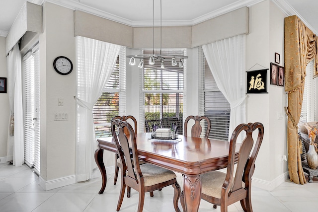 tiled dining area with crown molding and plenty of natural light