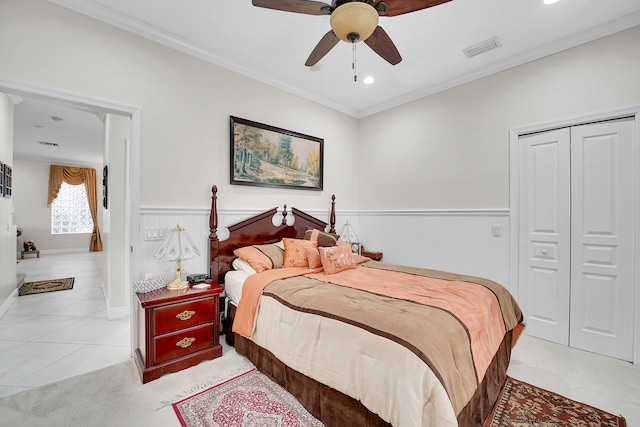 bedroom featuring ceiling fan, ornamental molding, and a closet