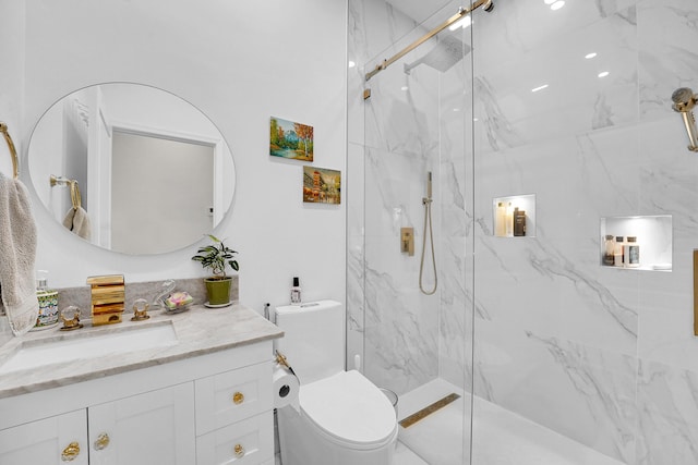 bathroom with a shower with shower door, toilet, and vanity