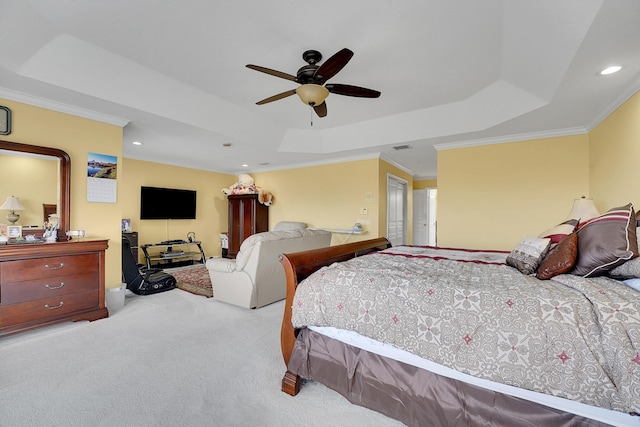 carpeted bedroom featuring ceiling fan, ornamental molding, and a tray ceiling