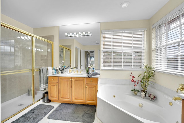 bathroom with a wealth of natural light, tile patterned flooring, separate shower and tub, and vanity