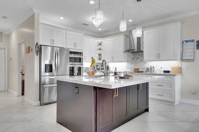 kitchen featuring white cabinets, wall chimney exhaust hood, decorative light fixtures, stainless steel appliances, and sink