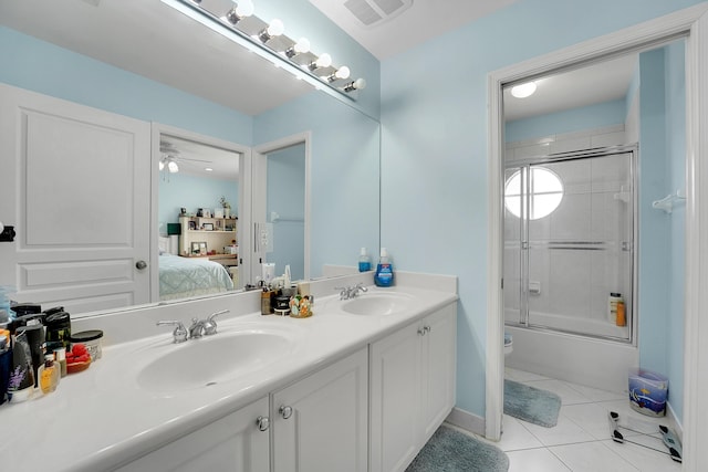 full bathroom featuring ceiling fan, bath / shower combo with glass door, vanity, toilet, and tile patterned floors