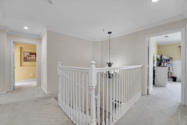 corridor with light colored carpet, a notable chandelier, and crown molding