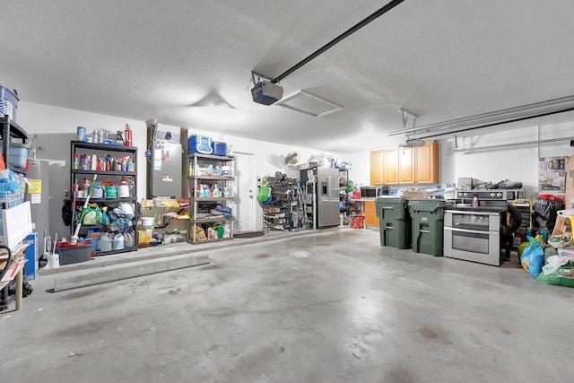 garage featuring stainless steel refrigerator with ice dispenser and a garage door opener