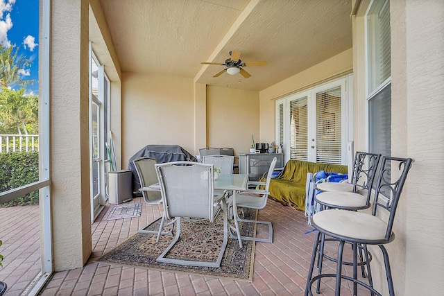 sunroom / solarium featuring ceiling fan