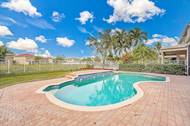 view of swimming pool with a yard and a patio