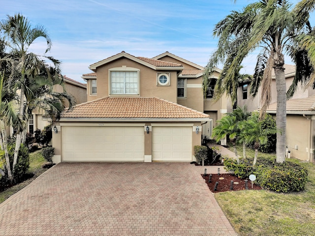 mediterranean / spanish-style home with a garage