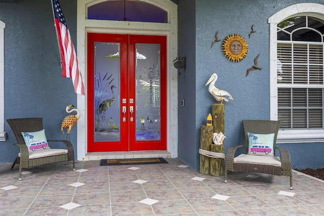 view of exterior entry featuring french doors