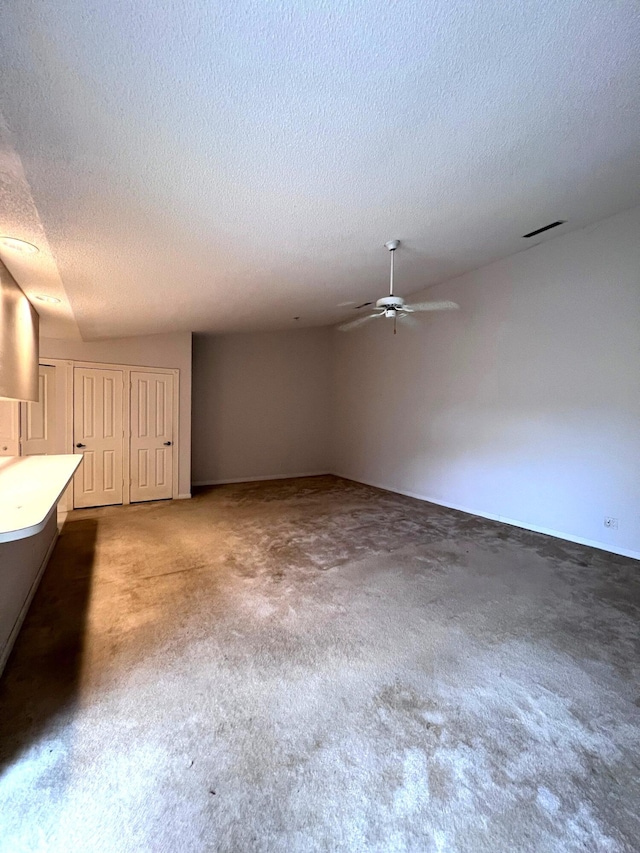 interior space with dark carpet and a textured ceiling