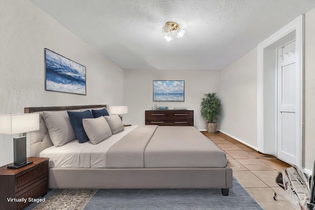 tiled bedroom featuring a textured ceiling