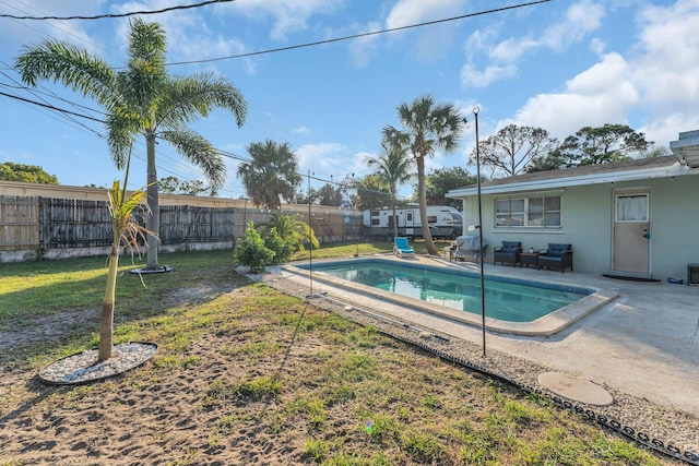 view of swimming pool with a patio area and a lawn