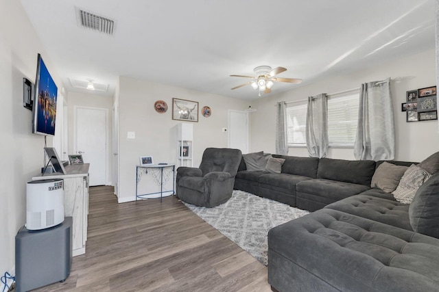 living room featuring ceiling fan and wood-type flooring