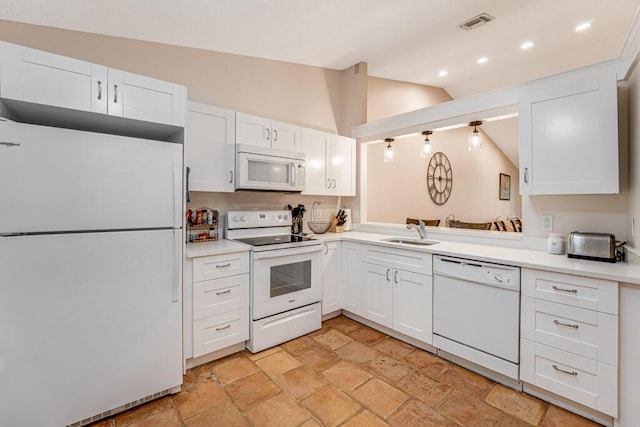 kitchen with lofted ceiling, white cabinets, sink, and white appliances