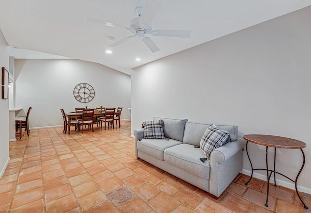 living room with ceiling fan and lofted ceiling