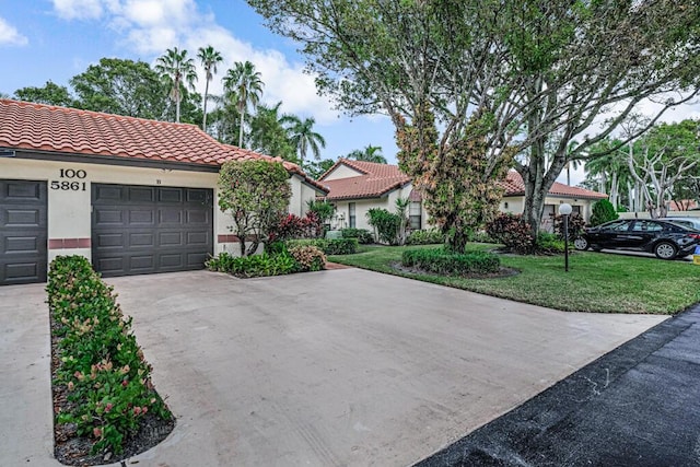 view of front of home with a garage and a front yard