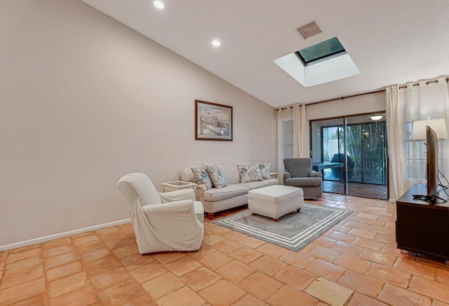 living room featuring vaulted ceiling with skylight