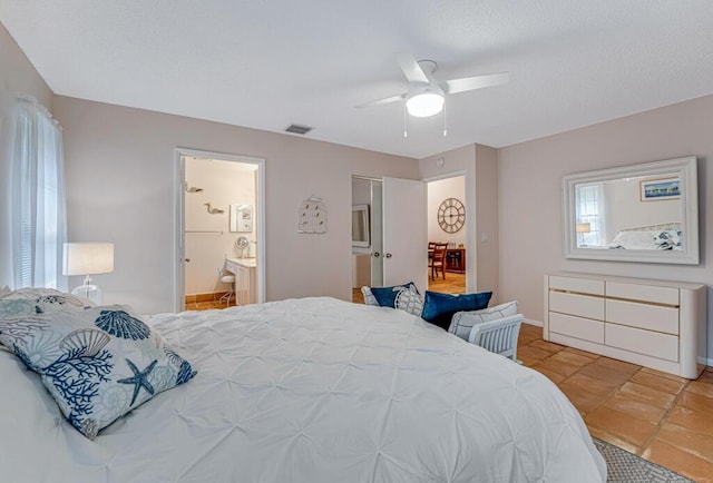 tiled bedroom featuring ceiling fan and ensuite bathroom