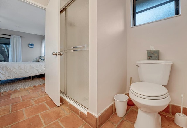 bathroom featuring toilet and walk in shower