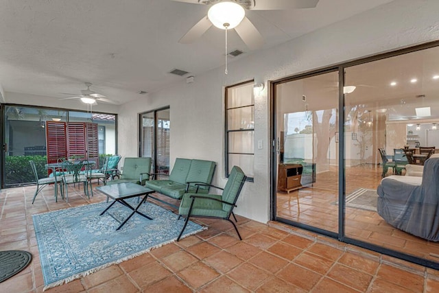 sunroom featuring ceiling fan