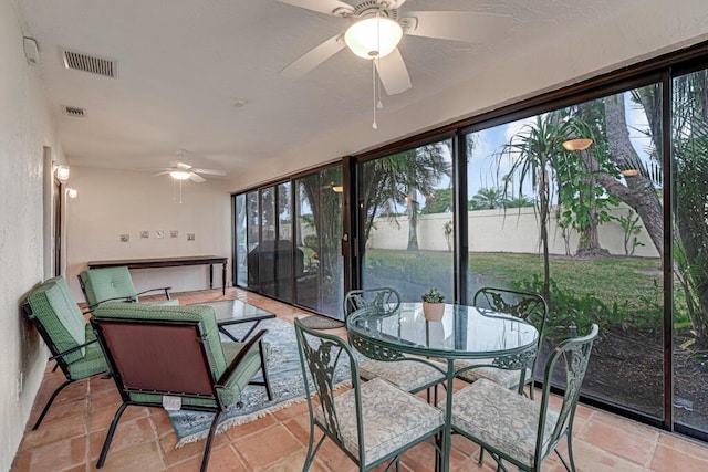 sunroom / solarium featuring ceiling fan