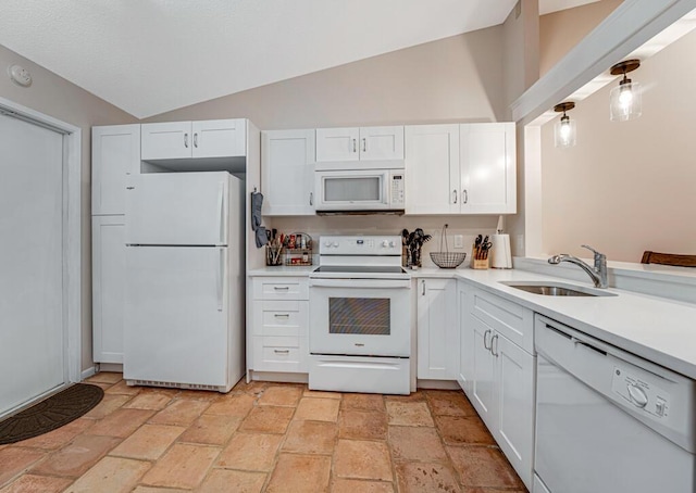 kitchen with vaulted ceiling, sink, white appliances, and white cabinetry