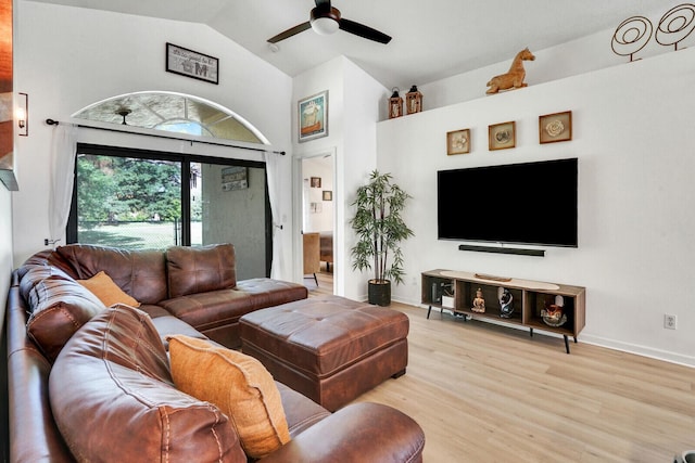 living area with ceiling fan, high vaulted ceiling, light wood-style flooring, and baseboards